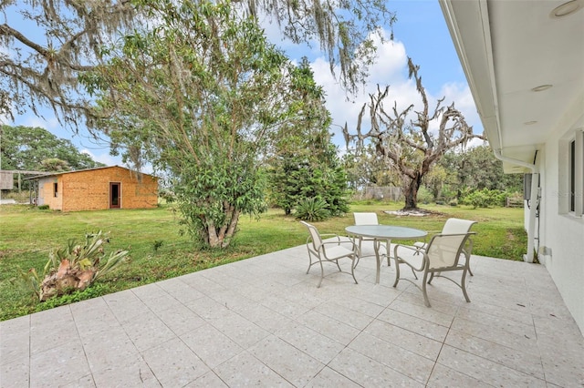 1635 SW Rodgers Ave, Arcadia, FL 34266 - view of patio / terrace with outdoor dining space and an outbuilding