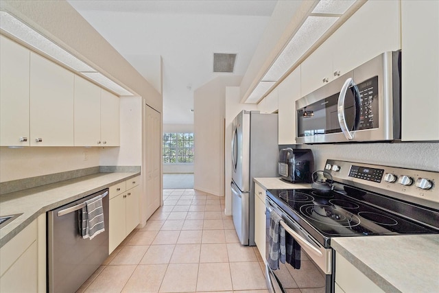 kitchen featuring light tile patterned floors, white cabinets, appliances with stainless steel finishes, visible vents, and light countertops