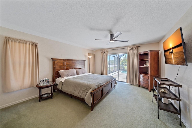 bedroom featuring a ceiling fan, light carpet, access to outside, and a textured ceiling