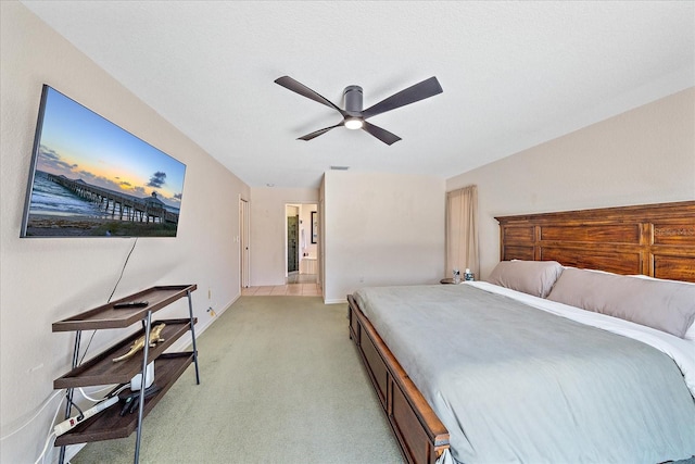 bedroom with visible vents, ceiling fan, light carpet, and baseboards