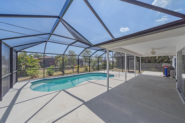 outdoor pool featuring a lanai, ceiling fan, and a patio