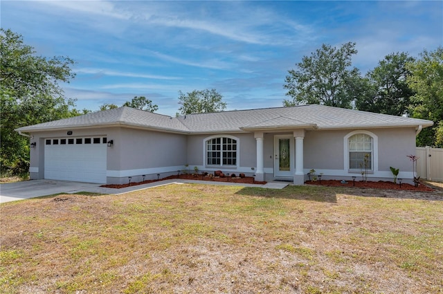 1773 Portage St, North Port, FL 34287 - single story home with a garage, driveway, a front lawn, and stucco siding