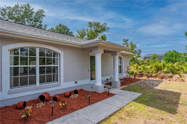 1773 Portage St, North Port, FL 34287 - doorway to property featuring stucco siding and a yard