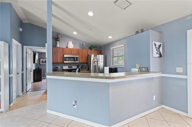 1773 Portage St, North Port, FL 34287 - kitchen featuring light tile patterned flooring, vaulted ceiling, appliances with stainless steel finishes, and visible vents
