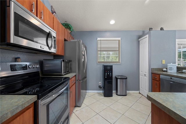 1773 Portage St, North Port, FL 34287 - kitchen featuring brown cabinets, dark countertops, appliances with stainless steel finishes, and a toaster