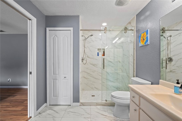 1773 Portage St, North Port, FL 34287 - bathroom with a marble finish shower, baseboards, toilet, and a textured ceiling