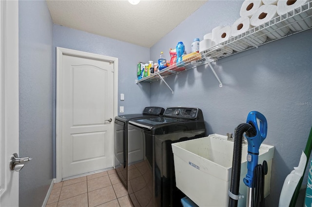 1773 Portage St, North Port, FL 34287 - washroom with laundry area, light tile patterned flooring, baseboards, washing machine and clothes dryer, and a sink