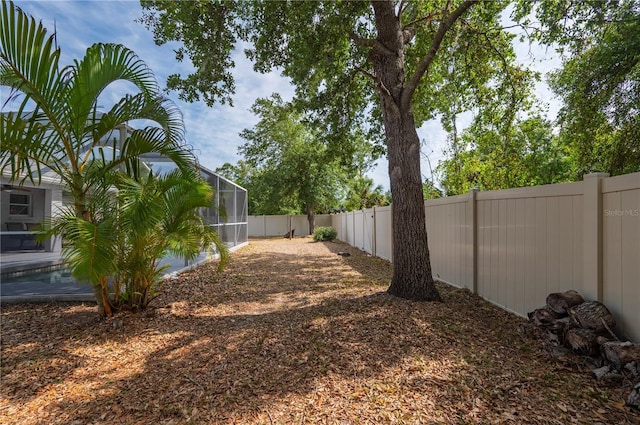 1773 Portage St, North Port, FL 34287 - view of yard featuring a fenced backyard and a lanai
