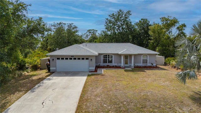 1773 Portage St, North Port, FL 34287 - ranch-style home with an attached garage, a front lawn, driveway, and stucco siding