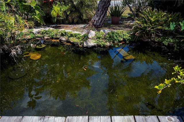 exterior details with a garden pond