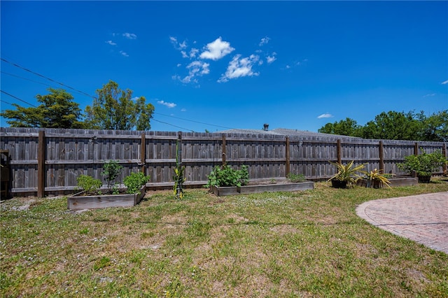 view of yard with a garden and a fenced backyard