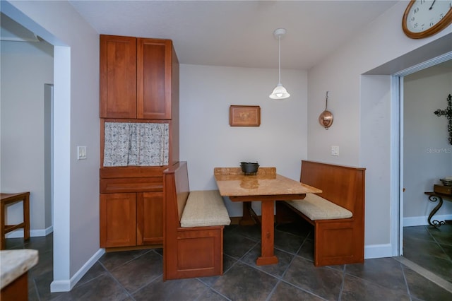 dining space featuring breakfast area and baseboards