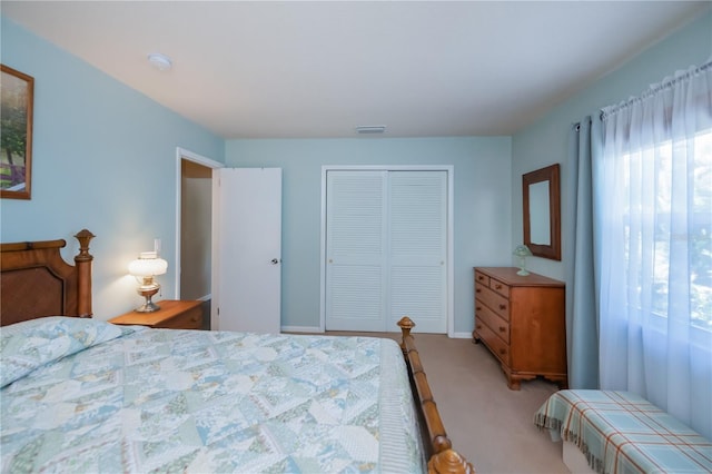 bedroom with visible vents, carpet floors, a closet, and multiple windows