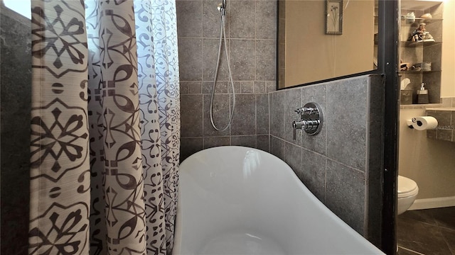 full bathroom with toilet, a soaking tub, curtained shower, and tile walls