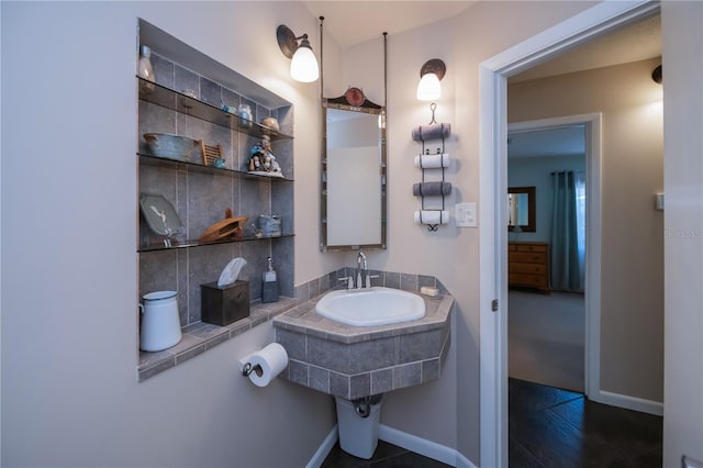 bathroom with baseboards and a sink