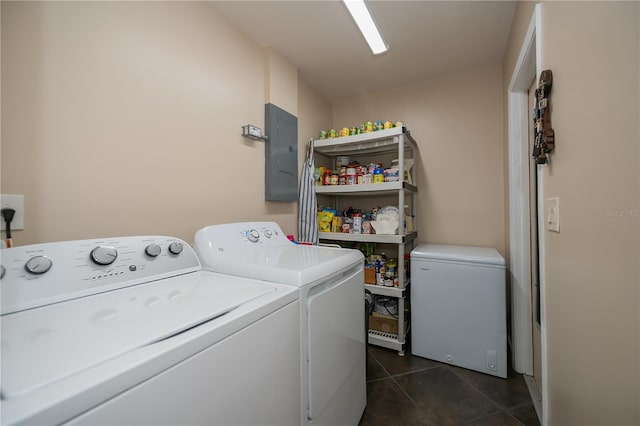 laundry area with electric panel, dark tile patterned flooring, independent washer and dryer, and laundry area