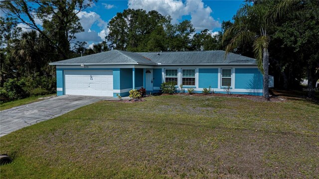 3175 Lakatos St, North Port, FL 34286 - single story home featuring stucco siding, a front lawn, driveway, and a garage