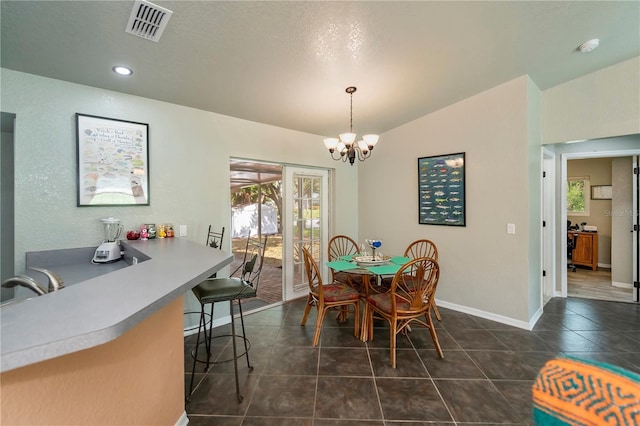 3175 Lakatos St, North Port, FL 34286 - dining room featuring a chandelier, visible vents, baseboards, and dark tile patterned flooring