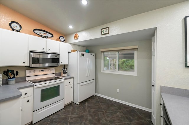3175 Lakatos St, North Port, FL 34286 - kitchen featuring baseboards, recessed lighting, white cabinetry, white appliances, and dark tile patterned floors