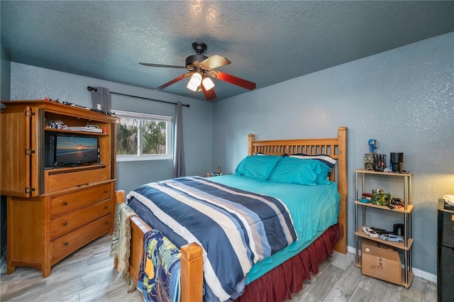 3175 Lakatos St, North Port, FL 34286 - bedroom featuring a textured wall, a textured ceiling, and light wood-style flooring