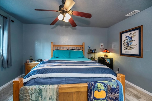 3175 Lakatos St, North Port, FL 34286 - bedroom with a textured ceiling, visible vents, baseboards, a ceiling fan, and wood finished floors