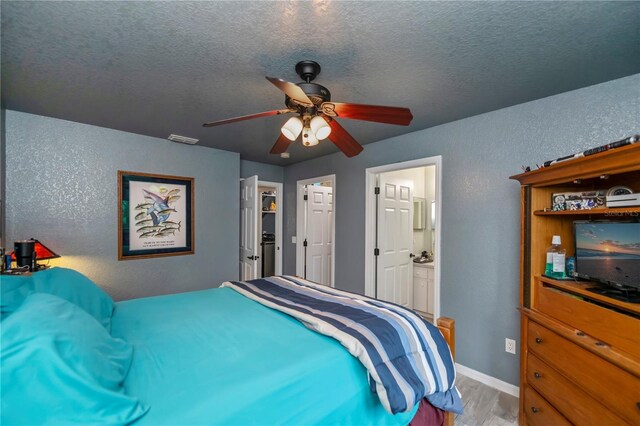 3175 Lakatos St, North Port, FL 34286 - bedroom with a textured ceiling, visible vents, wood finished floors, ceiling fan, and a textured wall