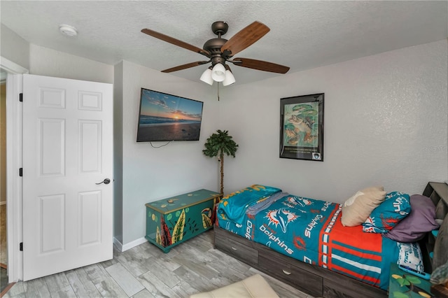 3175 Lakatos St, North Port, FL 34286 - bedroom featuring baseboards, a ceiling fan, wood finished floors, and a textured ceiling