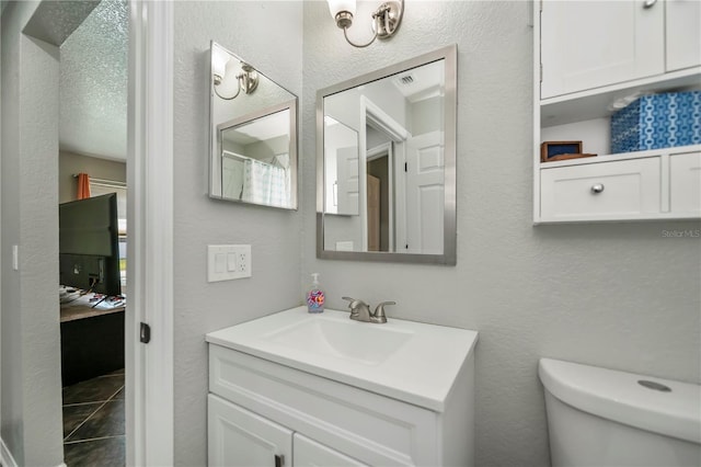 3175 Lakatos St, North Port, FL 34286 - bathroom featuring plenty of natural light, a textured wall, visible vents, toilet, and vanity