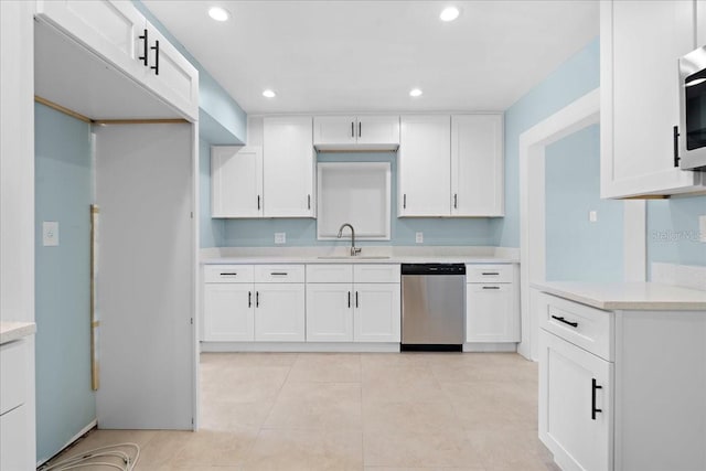 kitchen featuring recessed lighting, light countertops, dishwasher, a sink, and white cabinetry