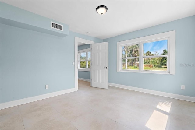 unfurnished bedroom featuring visible vents and baseboards