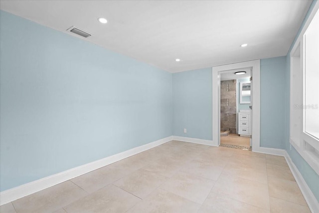 unfurnished room featuring light tile patterned floors, baseboards, visible vents, and recessed lighting