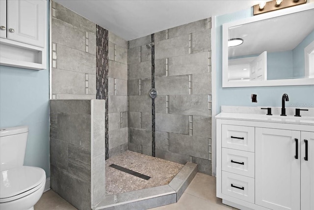 full bathroom featuring a shower stall, toilet, vanity, and tile patterned floors