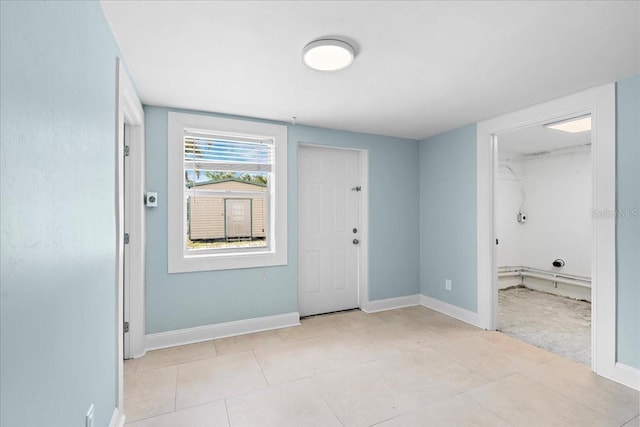 entrance foyer with baseboards and light tile patterned flooring