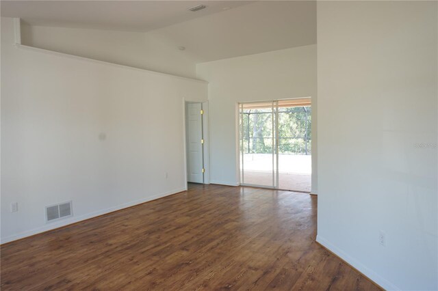 29211 Picador St, Punta Gorda, FL 33982 - unfurnished room featuring vaulted ceiling, baseboards, and dark wood-style floors