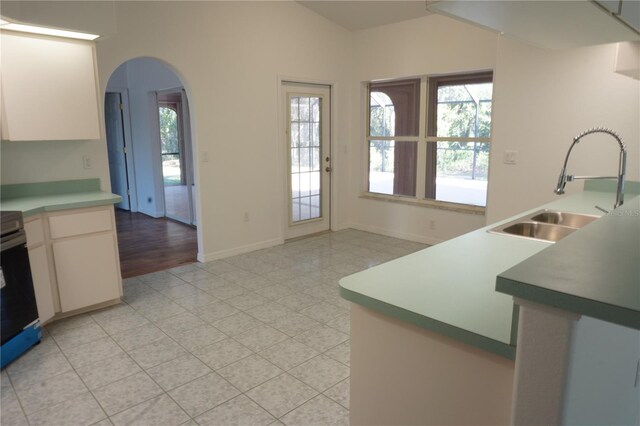 29211 Picador St, Punta Gorda, FL 33982 - kitchen with a sink, arched walkways, baseboards, white cabinetry, and stainless steel electric range oven