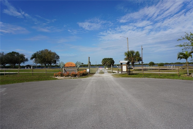 29211 Picador St, Punta Gorda, FL 33982 - view of asphalt road featuring a gate and street lights