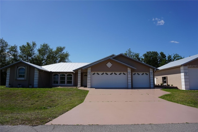 29211 Picador St, Punta Gorda, FL 33982 - ranch-style house featuring an attached garage, driveway, a front yard, and metal roof