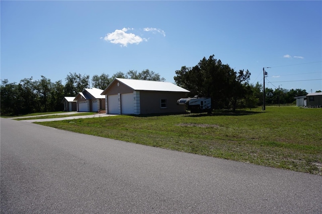 29211 Picador St, Punta Gorda, FL 33982 - view of property exterior with a lawn, an outbuilding, and a detached garage