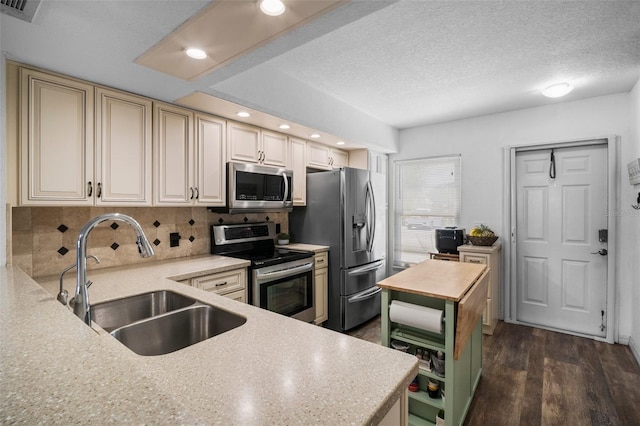 26290 Rampart Blvd Unit D, Punta Gorda, FL 33983 - kitchen featuring appliances with stainless steel finishes, light countertops, decorative backsplash, dark wood-style flooring, and cream cabinets