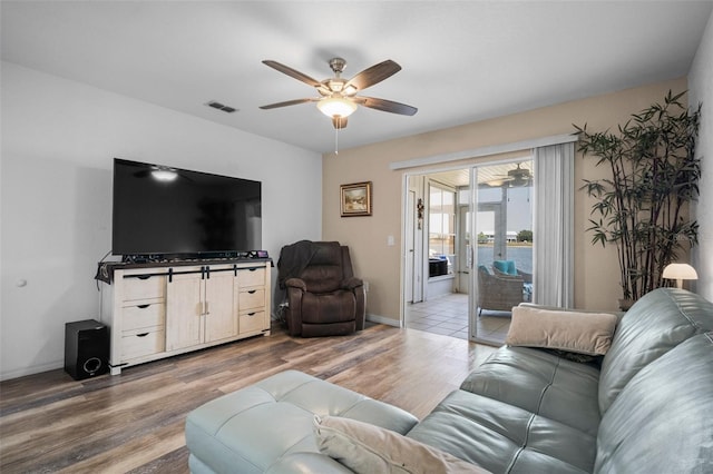 26290 Rampart Blvd Unit D, Punta Gorda, FL 33983 - living room with a ceiling fan and light wood finished floors