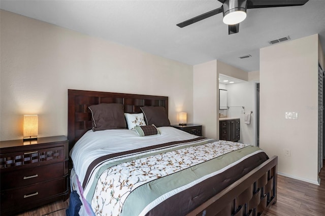 26290 Rampart Blvd Unit D, Punta Gorda, FL 33983 - bedroom featuring wood finished floors, ensuite bath, and a ceiling fan