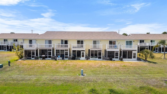26290 Rampart Blvd Unit D, Punta Gorda, FL 33983 - back of house featuring a sunroom and a lawn