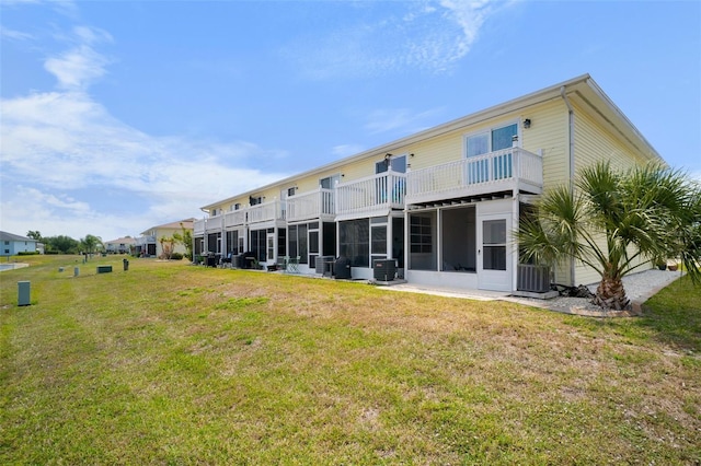 26290 Rampart Blvd Unit D, Punta Gorda, FL 33983 - rear view of house with a balcony, a lawn, and a sunroom