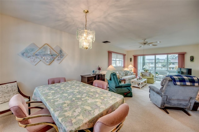 1432 Tropic Ter Unit 1432, North Fort Myers, FL 33903 - dining space featuring light carpet, a chandelier, and a ceiling fan