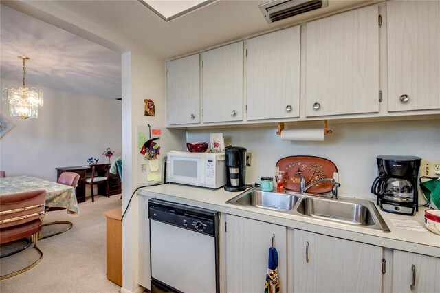 1432 Tropic Ter Unit 1432, North Fort Myers, FL 33903 - kitchen featuring white appliances, a sink, light countertops, light colored carpet, and hanging light fixtures