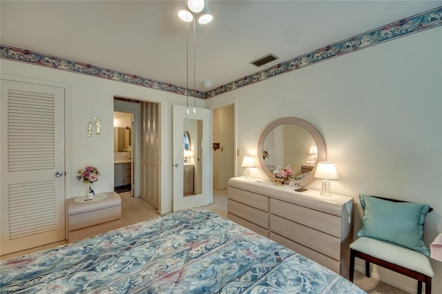 1432 Tropic Ter Unit 1432, North Fort Myers, FL 33903 - bedroom featuring light colored carpet and connected bathroom