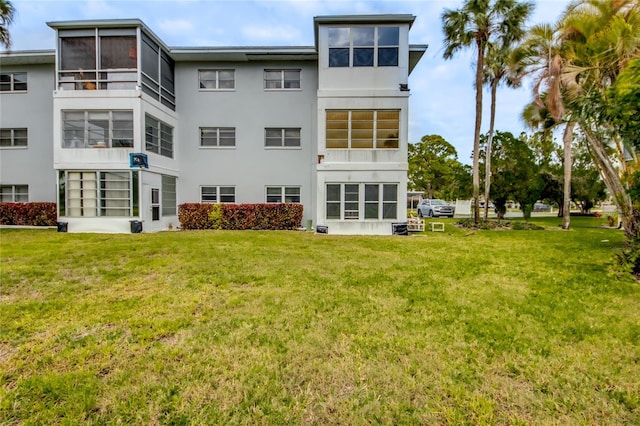 1432 Tropic Ter Unit 1432, North Fort Myers, FL 33903 - back of property featuring stucco siding and a lawn