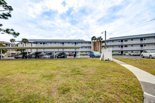 1432 Tropic Ter Unit 1432, North Fort Myers, FL 33903 - view of building exterior with covered and uncovered parking