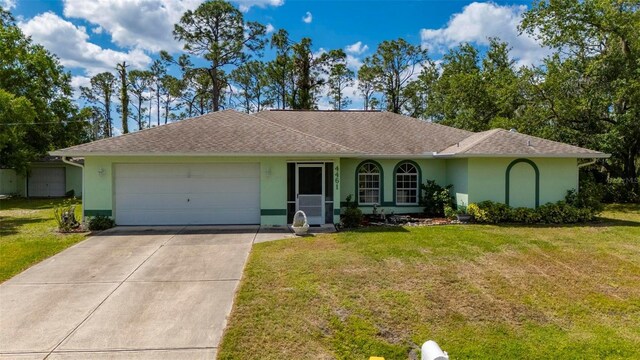 4461 La France Ave, North Port, FL 34286 - single story home featuring stucco siding, a garage, concrete driveway, and a front lawn