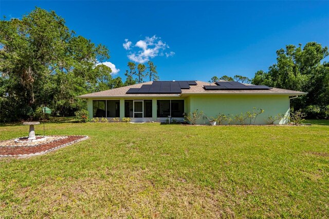 4461 La France Ave, North Port, FL 34286 - rear view of property featuring a sunroom, solar panels, and a yard